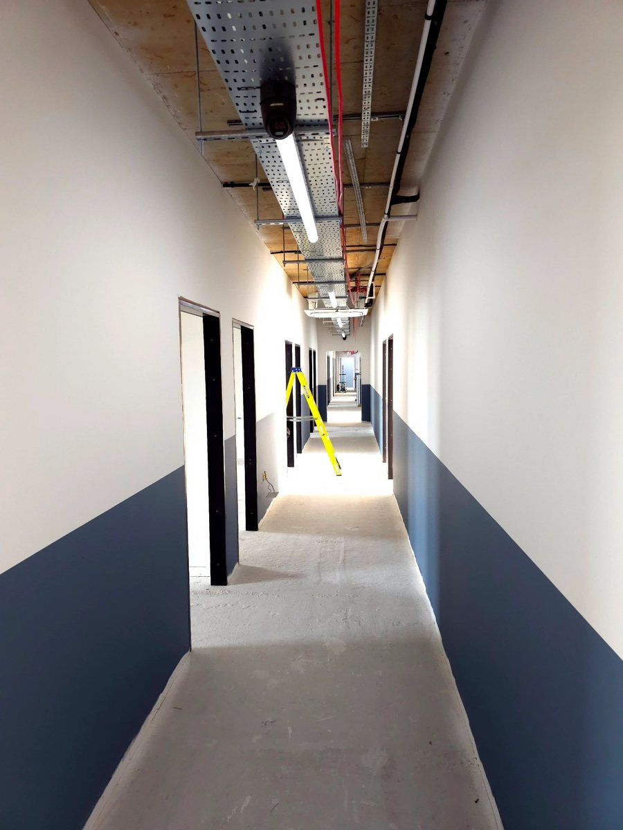 Commercial corridor with blue lower wall paint