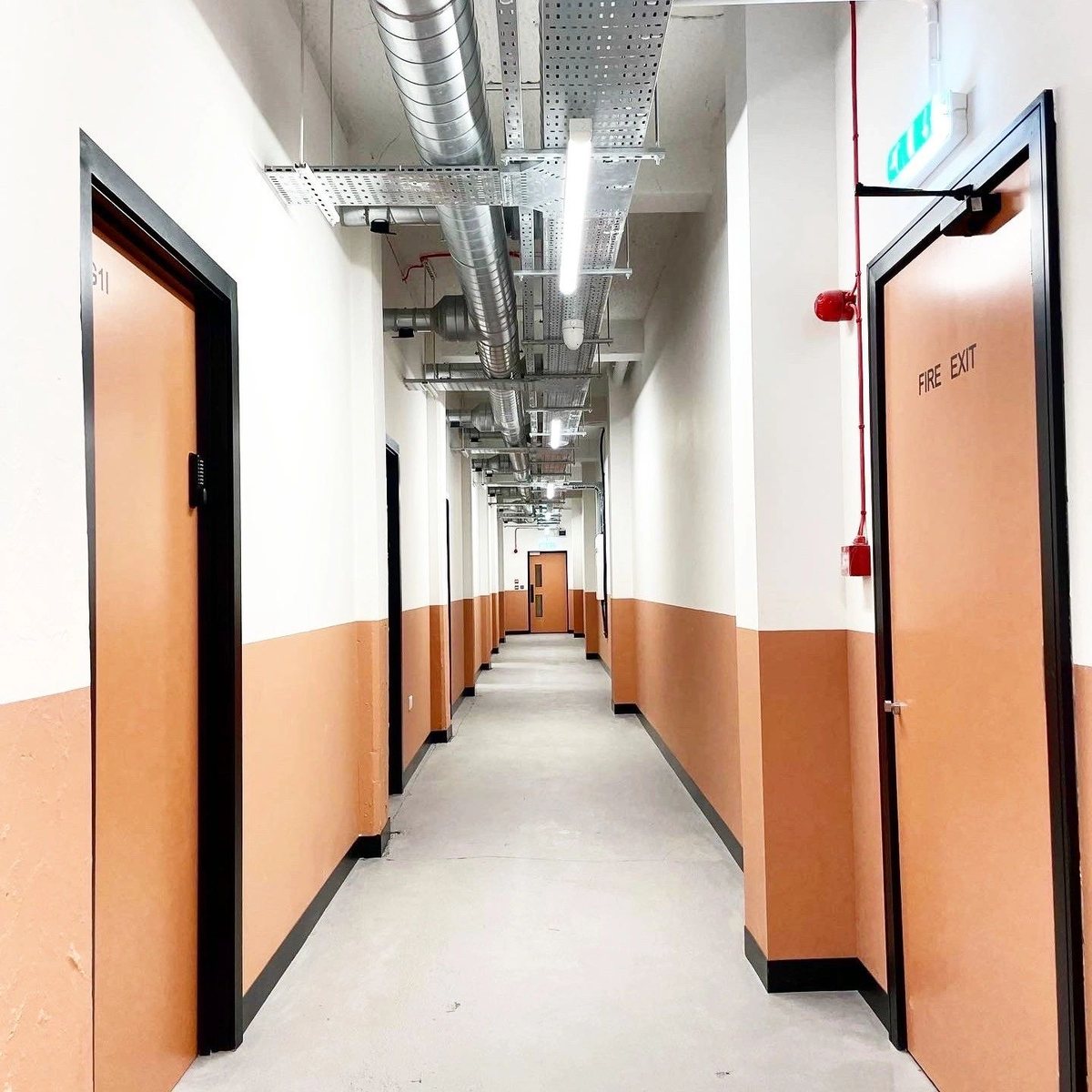 Commercial corridor with orange and white painted walls