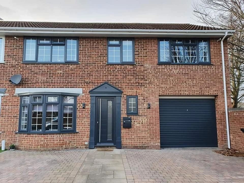Brick home with anthracite sprayed windows and garage door