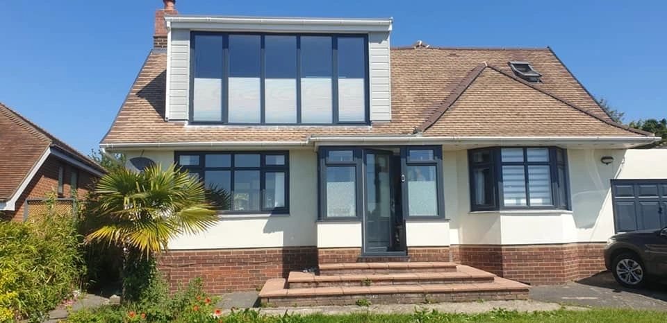 White rendered house with black sprayed window frames